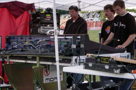 Several men in front of sound equipment